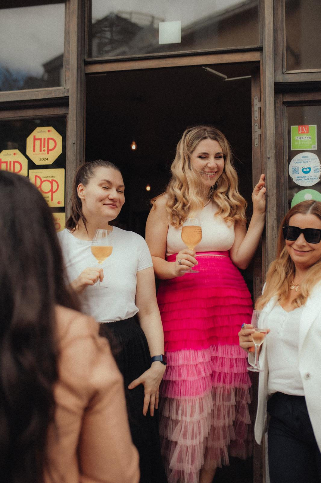 Guests with wine glasses at the door of a Kitchen 151 pop-up night