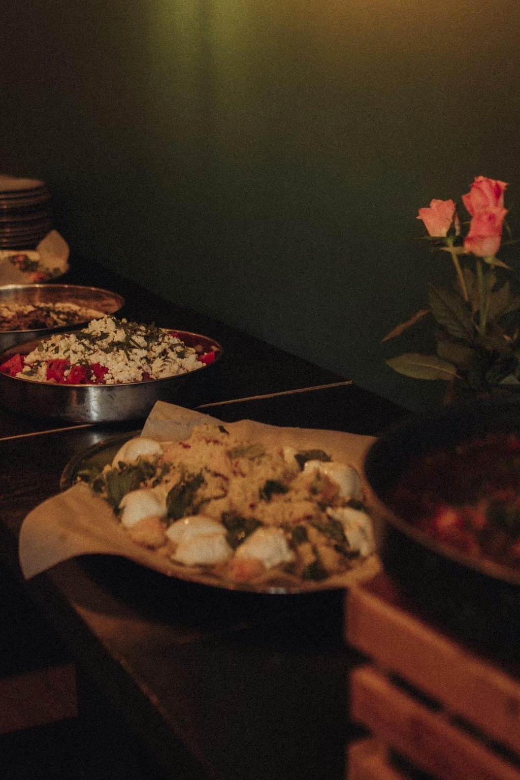 Catering spread of mezze bowls in warm evening light