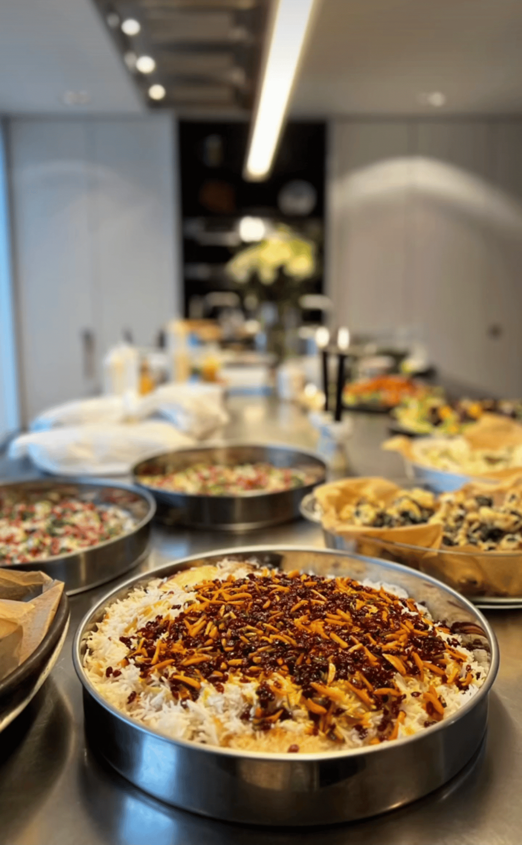 Catering buffet trays of rice and salads prepared in the kitchen